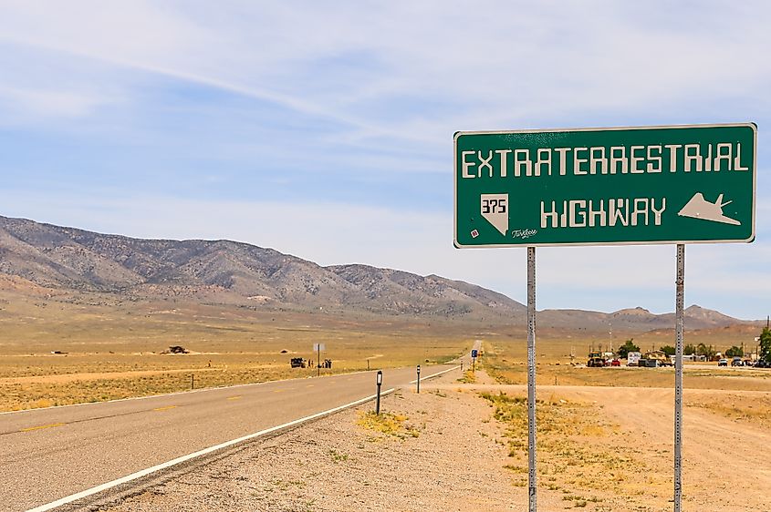RACHEL, NEVADA, USA - JUNE 3, 2017: Along the extraterrestrial Highway with a signboard at the right an the town Rachel in the back