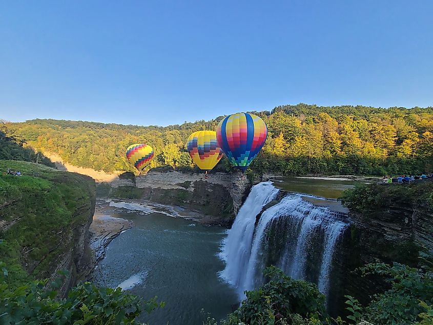 Hot Air Balloons float near a waterfall at Letchworth State Park, New York.