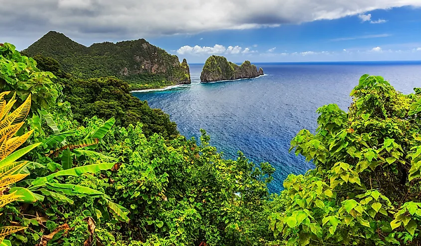 Rainforest-covered ridges meeting the coastline in American Samoa.