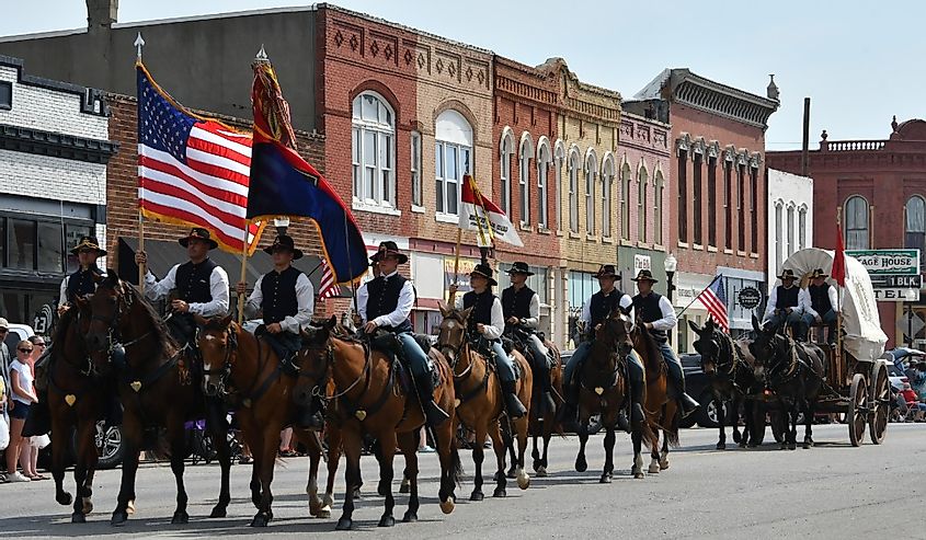 Members of the Fort Riley Commanding General's Mounted Color Guard outfitted in the uniforms and equipment of the Civil War ride in the Washunga Days Parade
