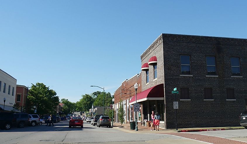 People and cars on the street in downtown Siloam Springs, Arkansas.
