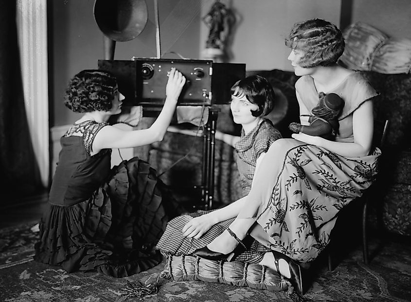 A group of women gathered around a radio in 1920.