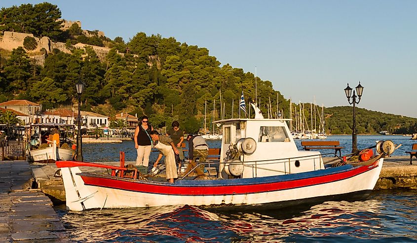 Unidentified woman buying fish from fishing boat at Vonitsa, Ambracian Gulf, Greece
