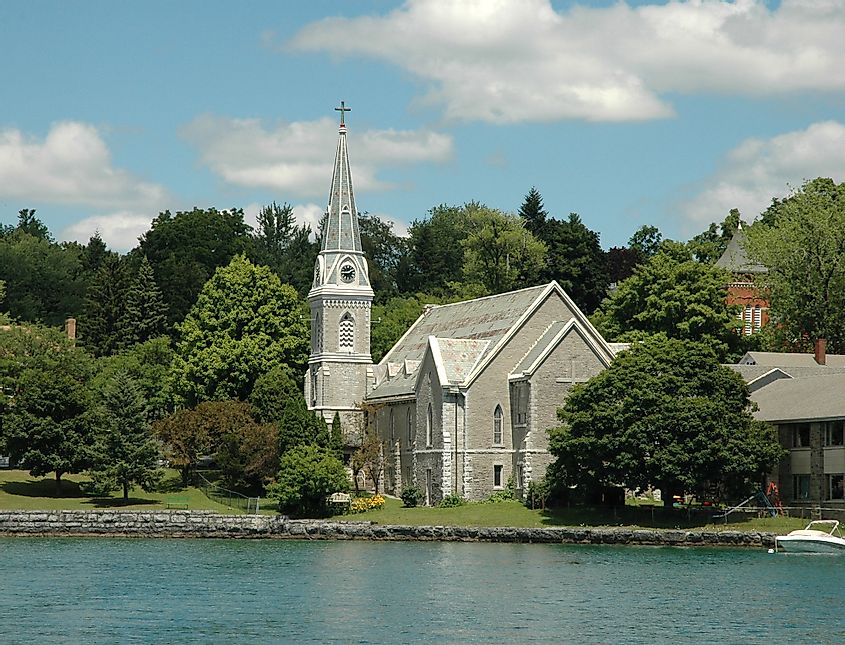 Lake front Church with Steeple and clock tower.