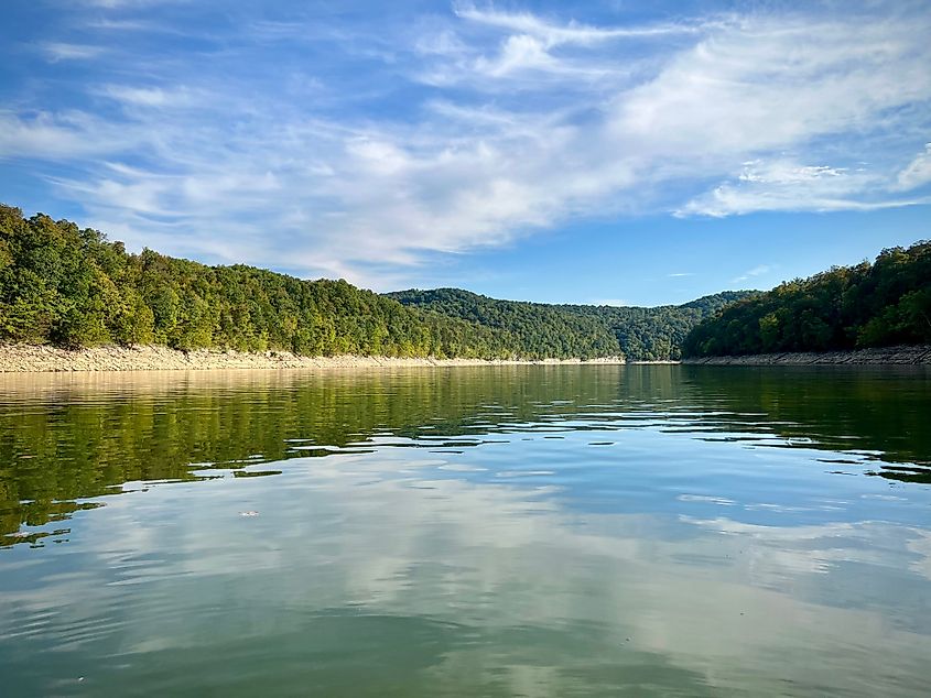 A perfect day on Lake Cumberland, with clear blue skies, calm waters, and scenic tree-lined shores.