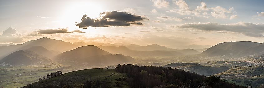 A breathtaking aerial panoramic view of Apennine Mountains under bright sunlight during golden hour