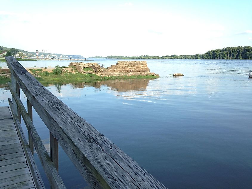 Weathered wood rails along the Mississippi River in Grafton, Illinois, with beautiful waters in the background.