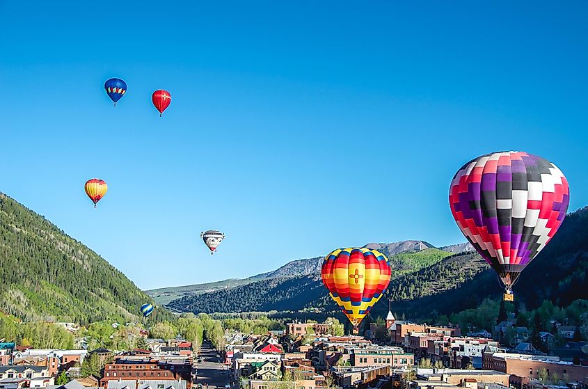 Balloon festival in Telluride Hot Air balloons flying over Town in the morning, Telluride, Colorado, via Tita77 / Shutterstock.com