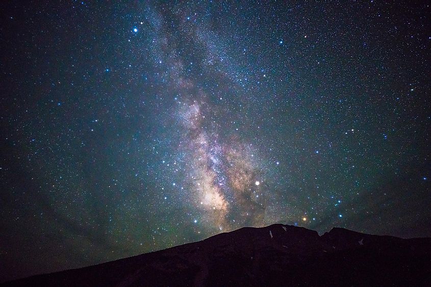 The Milky Way dazzles in the night sky above a mountainscape