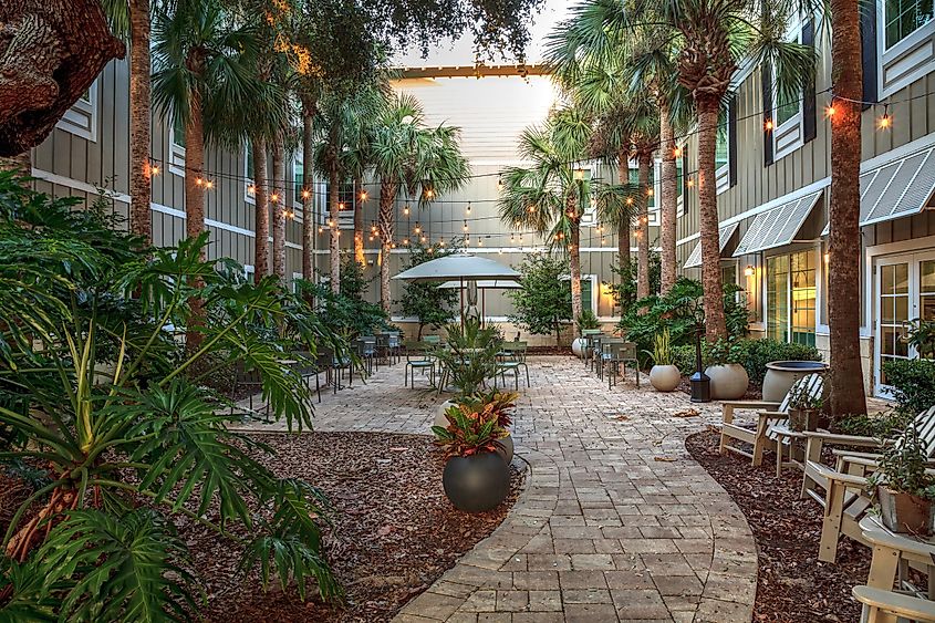 Courtyard with lights and tables at the Hampton Inn in New Smyrna Beach, Florida at sunrise, via sunflowermomma / Shutterstock.com