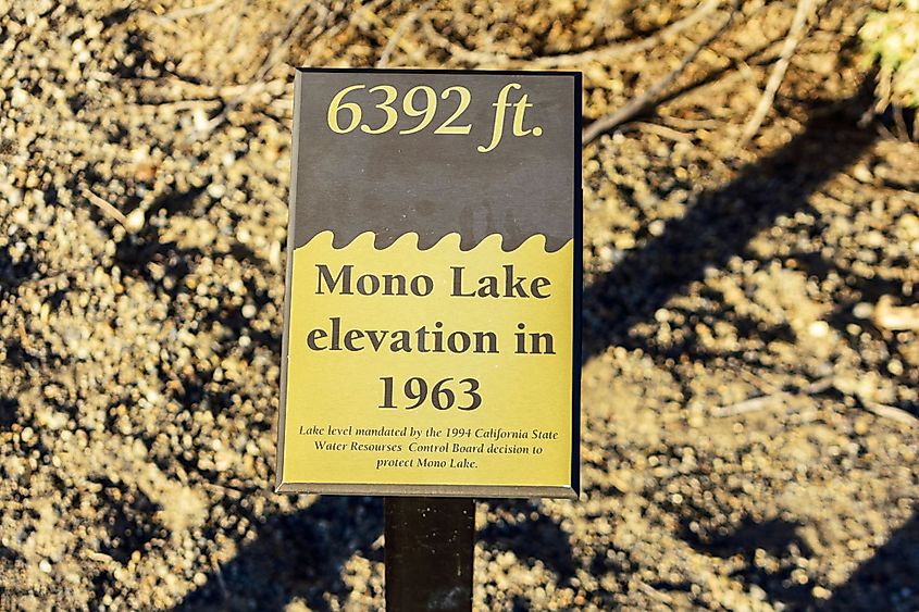 Mandated Mono Lake water level sign on dry lake bed in Mono Lake, California