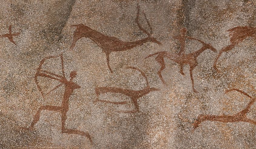 red prehistoric drawings on the wall in a cave