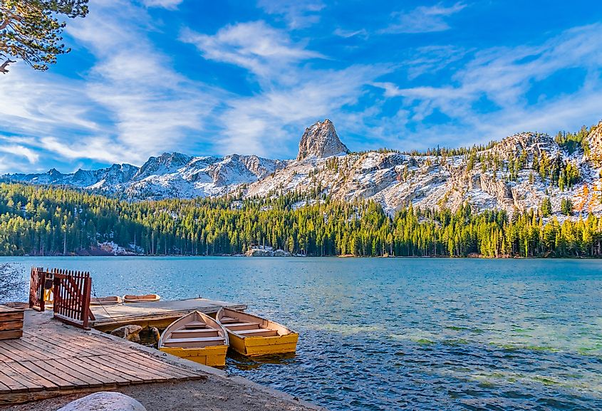 Boats sit at dock at Lake George under the watchful eye of the Crystal Crag peak. This peak is in Mammoth Lakes in Central California