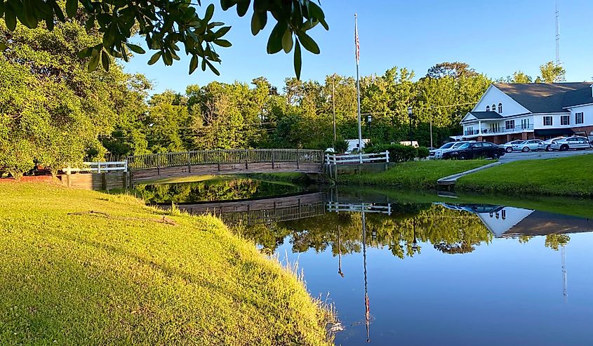 Countryside view of Wooden bridge with reflections at J F Gregory City Park, Richmond Hill , Georgia.