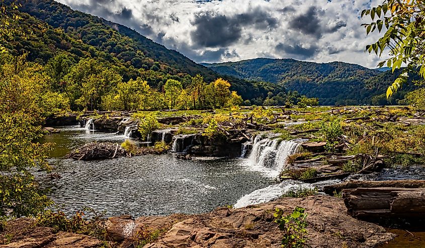 Sandstone Falls on the New River at New River Gorge National Park and Preserve during the Autumn leaf color change near Hinton, West Virginia.