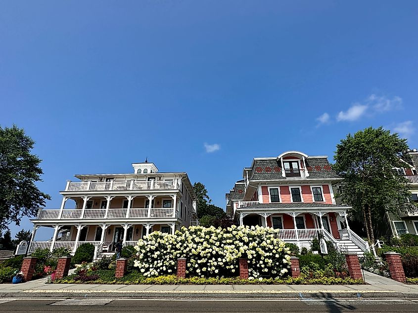 Old Saybrook, Connecticut, USA - Two historic buildings at Saybrook Point Resort and Marina, with a flower garden in front.