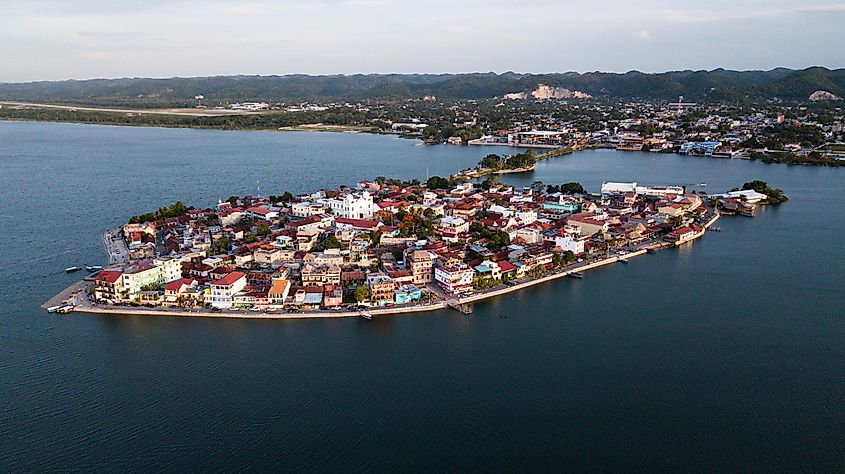 A small island town surrounded by blue water. 