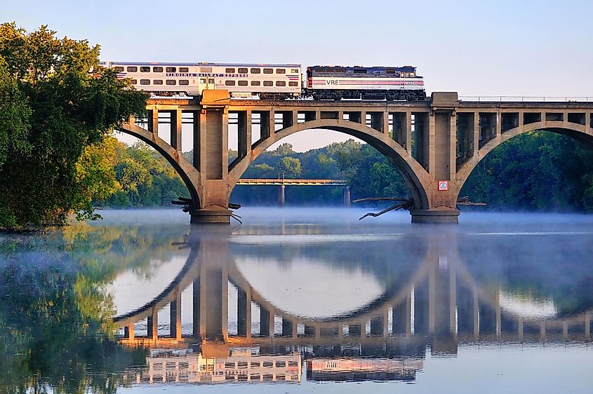 FREDERICKSBURG, VIRGINIA - OCTOBER 1, 2009: An early morning Virgina Railway Express commuter train passes over the Rappahannock River en route to Washington, D.C.