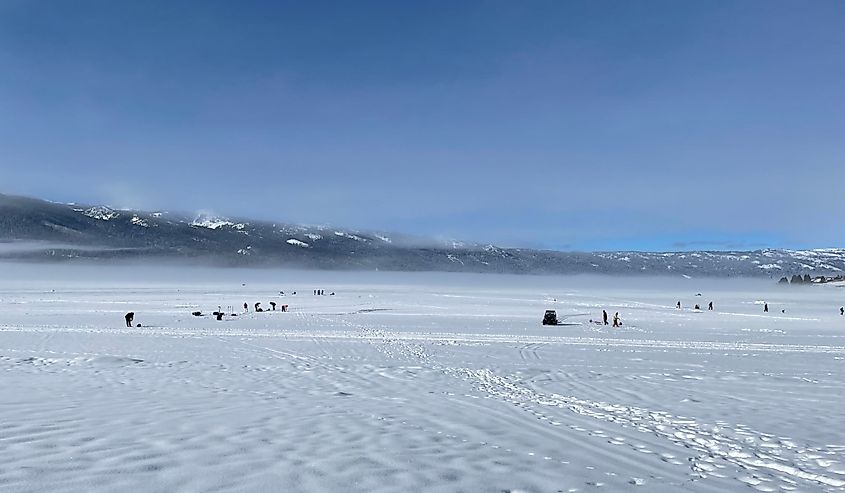 View of many ice fishers on Lake Cascade in winter.