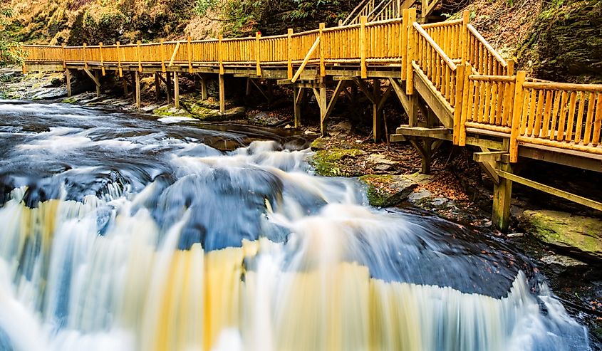 Waterfall on Little Bushkill creek. Wooden footpaths border the river. Little Bushkill Creek is a tributary of the Delaware River in eastern Pennsylvania