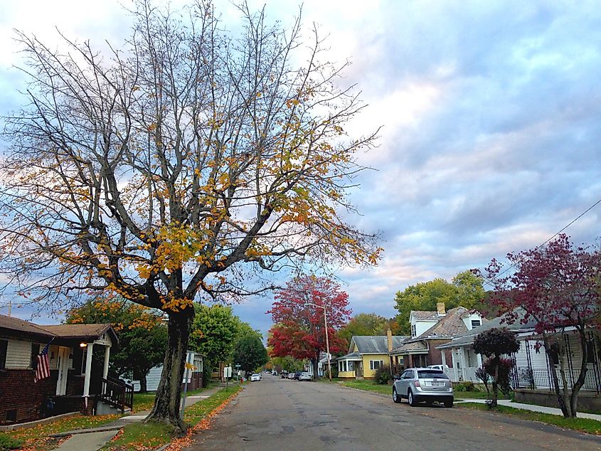 The last smattering of fall leaves are seen on trees lining a street of quaint Nelsonville, Ohio, via Wendy van Overstreet / Shutterstock.com