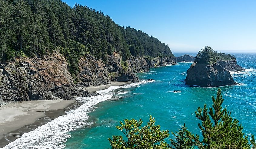 A sunny afternoon on the beach and rocky cliffs that are south of the Arch Rock in the southern part of the Oregon Coast.