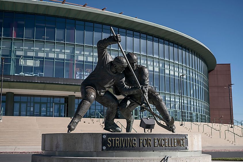 Maverik Center with ice hockey statue. 