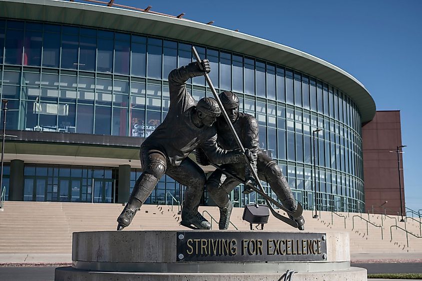 Maverik Center with ice hockey statue.
