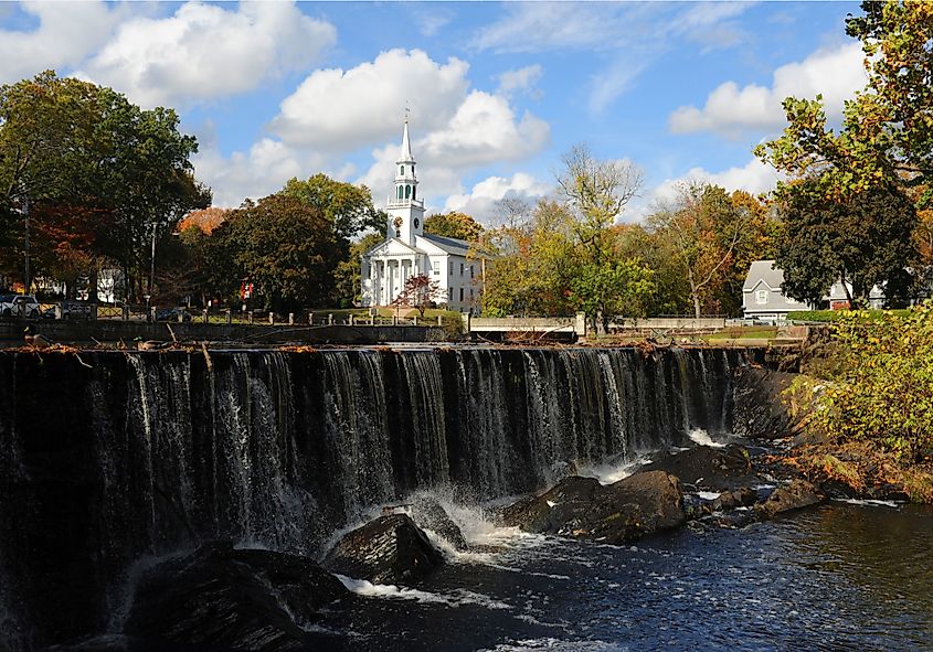 waterfall with church in background in the center of Milford, Connecticut.