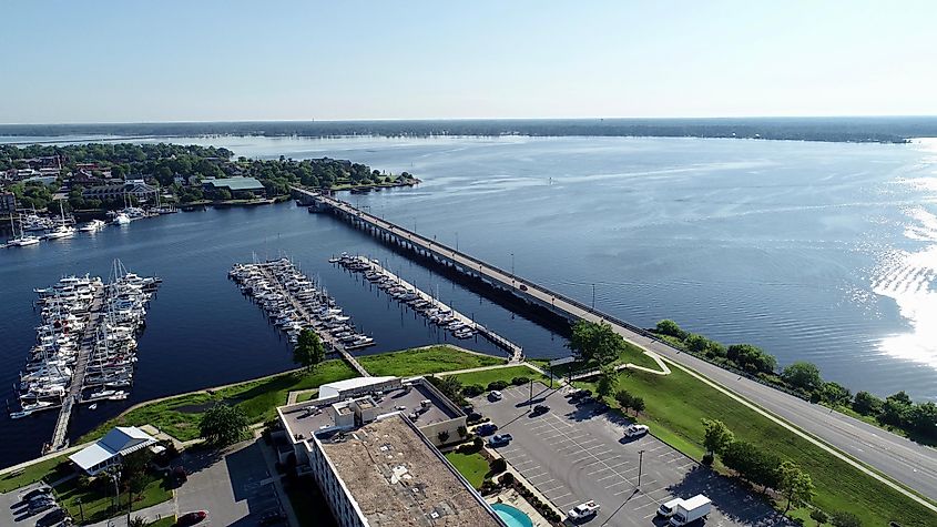 Several boats docked near a bridge in beautiful New Bern