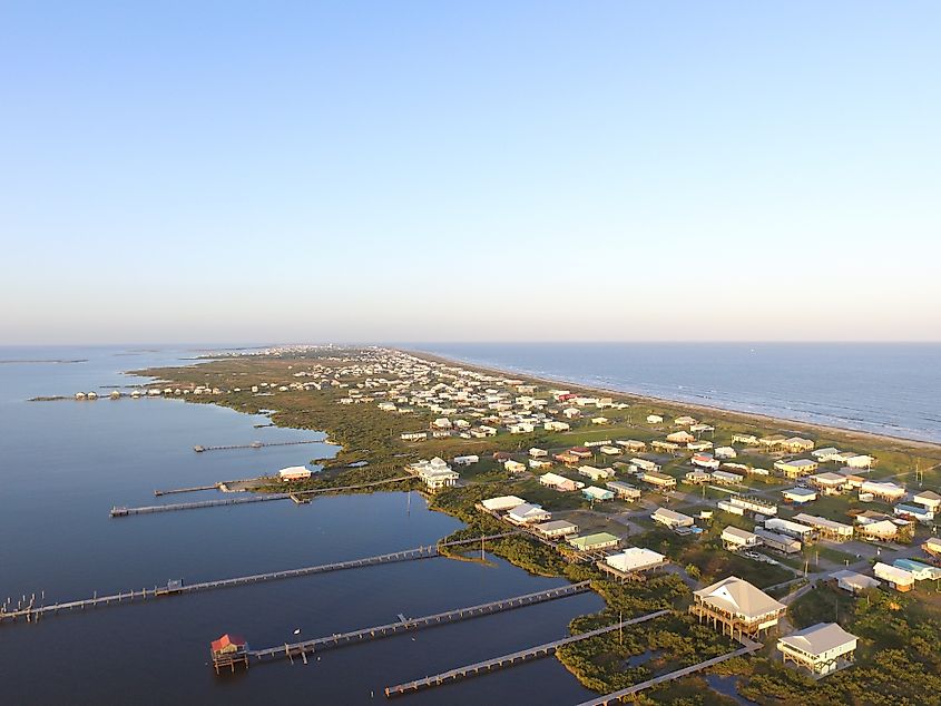 Stilt houses with long docks in the low-lying town of Grand Isle, Louisiana