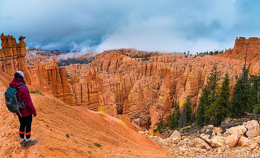 Hiker looking down a Peek-a-boo loop trail Bryce Canyon