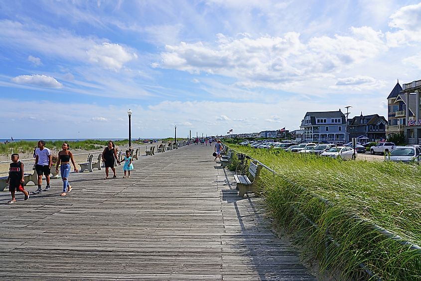 View of the boardwalk along the beach in Ocean Grove, a town on the New Jersey Shore, known for its historic Victorian houses.