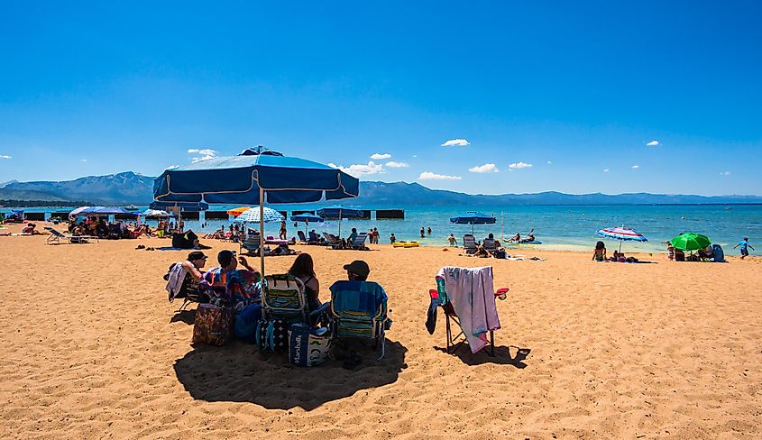 People enjoying the day at the beach in Lake Tahoe, via Asif Islam / Shutterstock.com