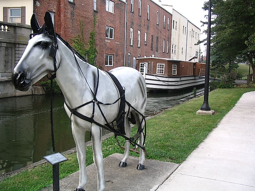 Photo Credit: WikimediaCommons. Canal boat exhibit at Memorial Park. Display features a life-sized metal horse tethered to a restored canal boat on the Miami-Erie Canal.