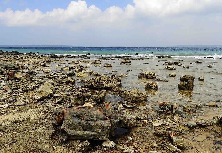 The rusted ruins of American military equipment from WWII on the beach at Million Dollar Point on the island of Espiritu Santo, Vanuatu (via: Nina B / Shutterstock)