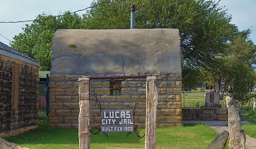 A shot of an Old Limestone City Jail in Lucas Kansas USA. With green grass and blue sky.