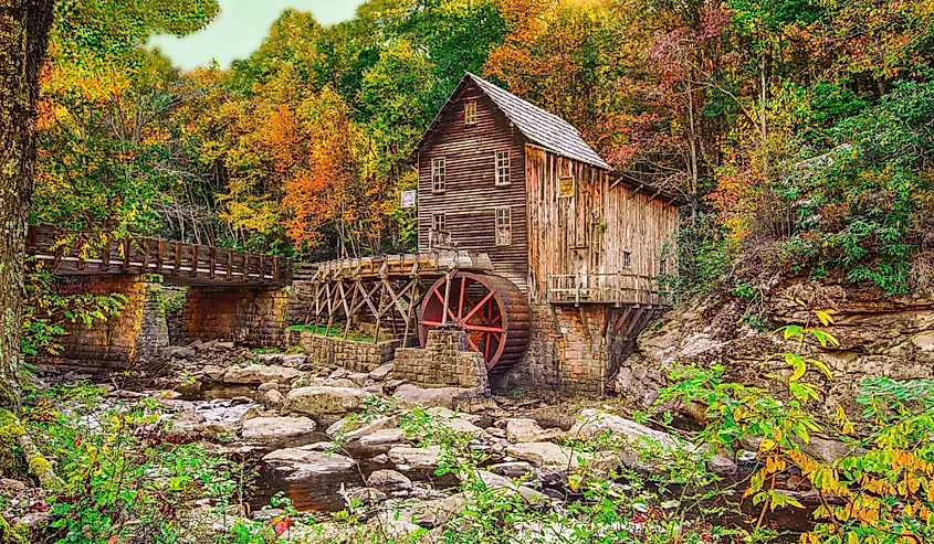 Autumn sun rays on fall foliage at Glade Creek grist mill at Babcock State Park near Fayetteville WV