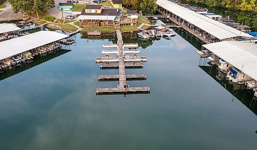 Aerial drone view of a lake marina and restaurant with boats storage slips waterfront gasoline pumps on Tims Ford lake in Winchester Tennessee.