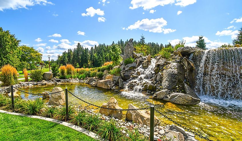 Colorful landscaping at a public waterfall and pond near the McEuen Park area of the resort mountain town of Coeur d'Alene, Idaho.