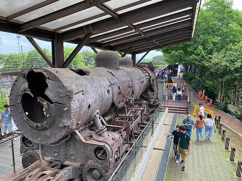 A rusty and dilapidated steam engine on display.