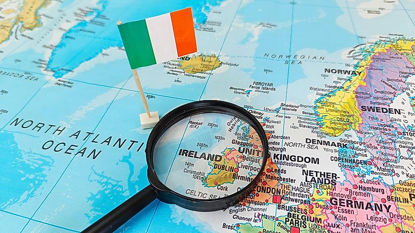 Ireland through magnifying glass with Ireland flag.