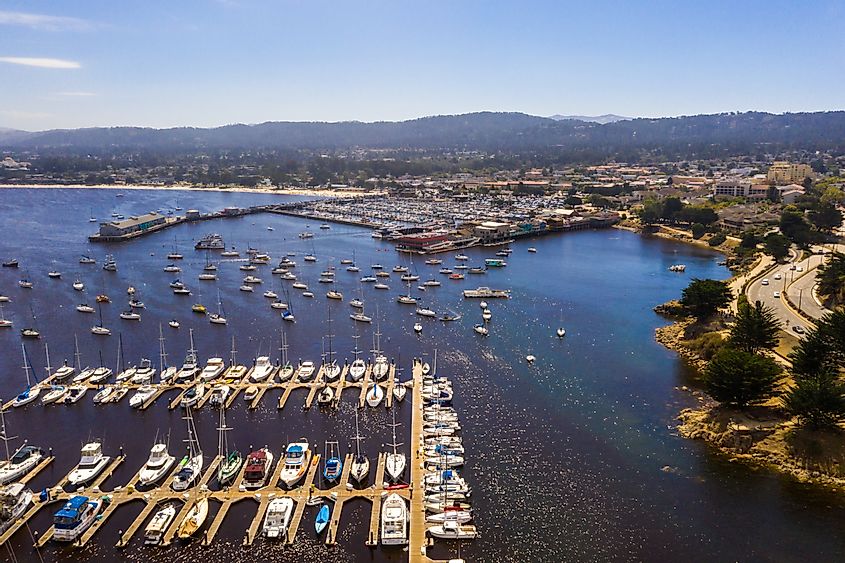 Aerial view of the Monterey Bay Aquarium, Pacific Grove with many yachts docked by the coastline in Monterey, central California