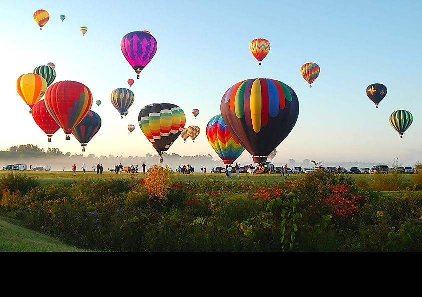 The Adirondack Balloon Festival in Queensbury, New York, featuring colorful hot air balloons.