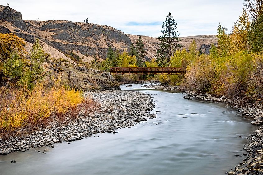 Naches, Washington: Autumn colors and footbridge on the Tieton River.