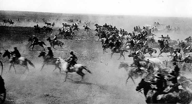 1889 Oklahoma Land Rush. Caption: Oklahoma Land Rush of 1889. en:John Sherwood is on the white horse. en:Elias McClenny is ahead of John. en:Fred McClenny is just behind John. Source: McClenny Family Picture Album]