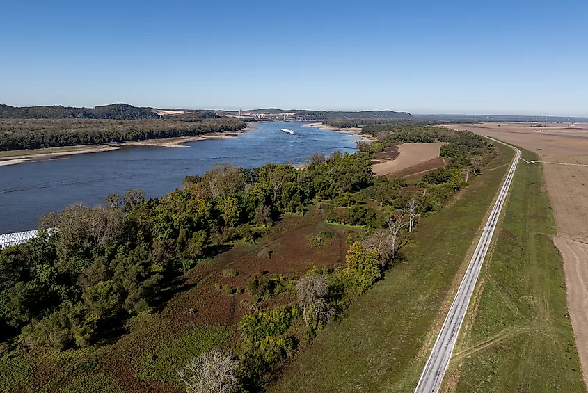 Mississippi River with barges during the fall dry season, Missouri and Illinois riverbanks.