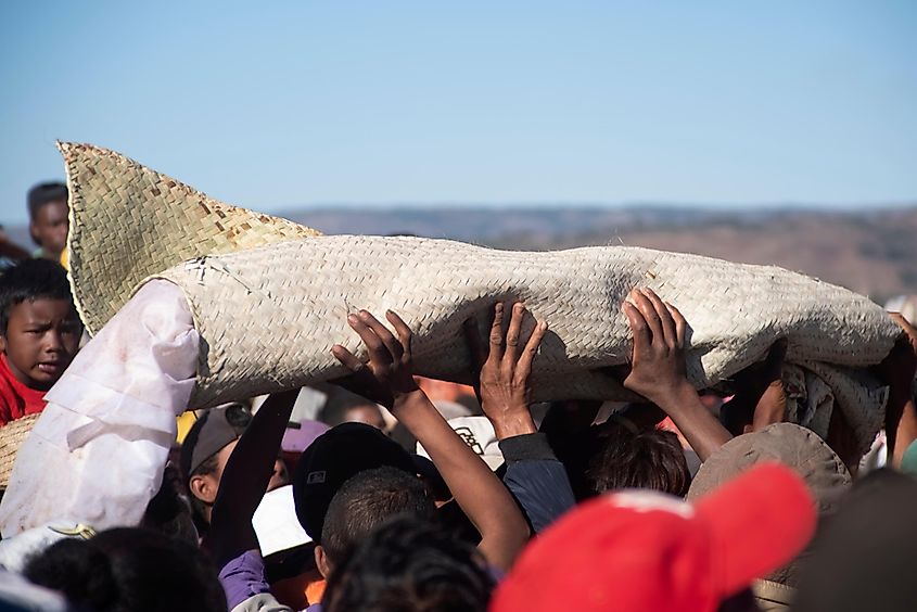 Family members carry shroud-wrapped remains during a Famadihana ceremony in Madagascar