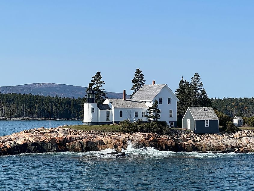 The Winter Harbor Lighthouse on Mark Island With Cadillac Mountain in the distance.