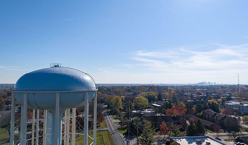 Aerial view of a water tower in Upper Arlington, OH, with Columbus skyline on the horizon.